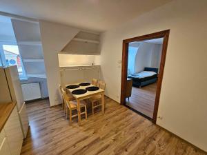 a room with a table and chairs and a bedroom at Apartament Czołgistów Centrum in Lębork