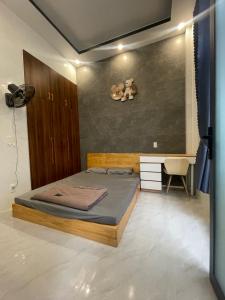 a bedroom with a bed with a teddy bear on the wall at Lauren Homestay in Tây Ninh
