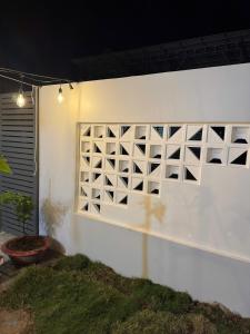 a white wall with a wine rack on it at Lauren Homestay in Tây Ninh