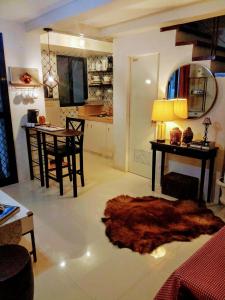 a living room with a table and a rug on the floor at Phoenix House Rental Properties in Gabi