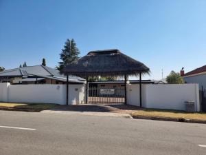 a house with a gazebo with a fence at La Belle Guesthouse Parys in Parys