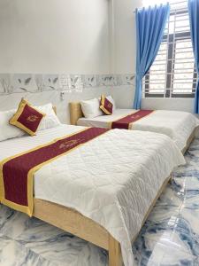 Postel nebo postele na pokoji v ubytování Ngọc Quý 2 Hotel Phan Rang