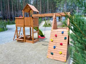 a wooden playground with a slide and a play structure at Къмпинг Alino Lake in Alino