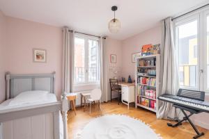 Dormitorio con cama, escritorio y teclado en Veeve - Seagull’s House, en Boulogne-Billancourt