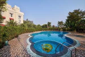 a swimming pool with a painting of a frog in it at Royal Kingdom Sarovar Portico Pilibhit in Pīlībhīt