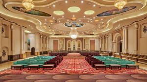 a large room with chairs and a large ceiling at Royal Kingdom Sarovar Portico Pilibhit in Pīlībhīt