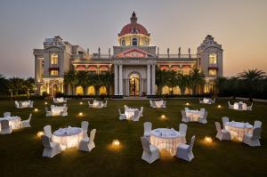 an aerial view of a building with tables and chairs at Royal Kingdom Sarovar Portico Pilibhit in Pīlībhīt +29 photos