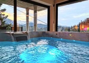 a hot tub in a house with a view of the mountains at Villa Dremissa in Pavliani