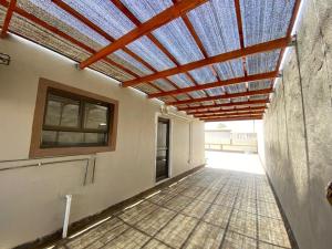 a building with a roof with a blue ceiling at Ehekevi Self Catering in Walvis Bay