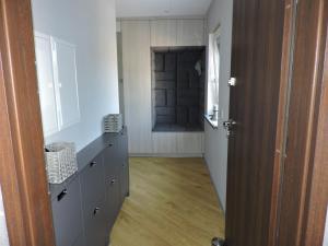 a room with a hallway with a closet and a door at Centro Residence in Kluczbork