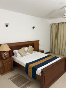 Postel nebo postele na pokoji v ubytování Serendib Beach Hotel
