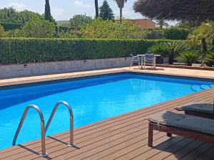 a swimming pool on a wooden deck next to at La Cambreta in Pedreguer