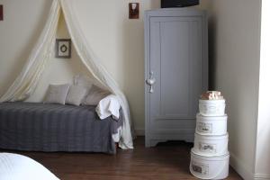 a bedroom with a bed with a canopy at L'Ancienne Boulangerie in Chavagnes
