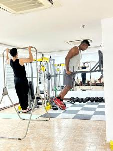 a man and a woman working out in a gym at Star Hotel and Spa Danang in Danang +37 photos