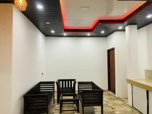 a row of chairs in a room with a ceiling at Nethuli Inn Ella in Ella