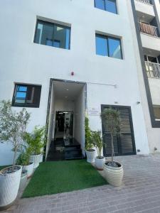 a white building with plants in front of it at Ista Vacation Homes Rental LLC in Dubai