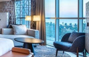 a living room with a couch and chairs and a table at Sheraton Jeddah Hotel in Jeddah