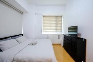 a bedroom with a white bed and a window at Premium 1BR unit at The Avant in Manila +38 photos