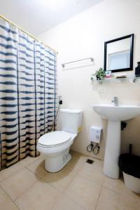 a bathroom with a toilet and a sink at Premium 1BR unit at The Avant in Manila