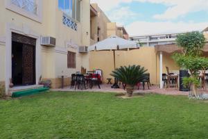 a courtyard of a building with a table and chairs at K Boutique Hotel - Pyramids & GEM - Roof in Cairo