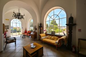 a living room with a couch and some windows at Tenuta Villa Tara in Sant'Angelo D'Ischia