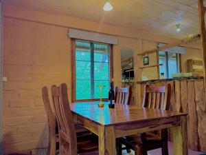 un tavolo da pranzo con sedie e una finestra di Maccys Cottages a Macclesfield