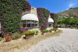a building with flowers on the side of it at Tenuta Villa Tara in Ischia