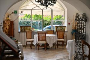 a dining room with a table and chairs and a window at Tenuta Villa Tara in Ischia