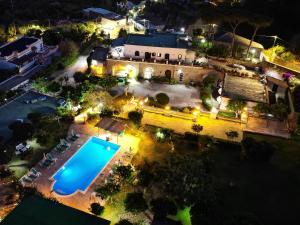 an aerial view of a house with a swimming pool at night at Tenuta Villa Tara in Ischia