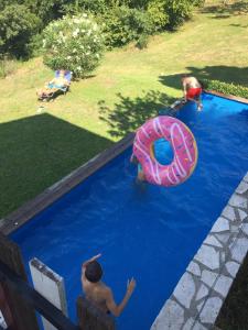 two children playing in a swimming pool with an inflatable at Holiday home with alpine panorama in Teolo