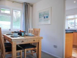 a kitchen with a wooden table with two chairs at 15 Beadon Road in Salcombe