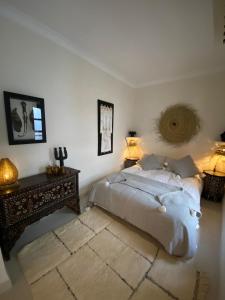 a bedroom with a bed and a table and two lamps at Riad Bacha Beldi in Marrakech