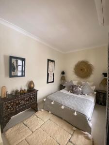 a bedroom with a bed and a table in it at Riad Bacha Beldi in Marrakech +33 photos