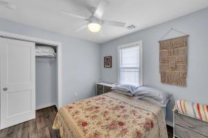 a bedroom with a bed and a ceiling fan at Cozy 3-BR Retreat, Four Blocks to Beach & Boardwalk home in Seaside Heights