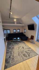 a living room with a couch and a rug at Centralapartment J3 in Schwerin +4 photos