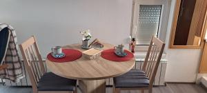 a dining room table with chairs and a wooden table with food on it at Srce Turopolja in Velika Gorica
