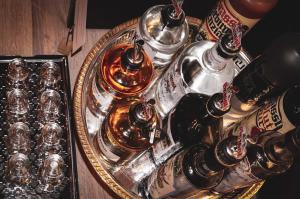 a tray with bottles and glasses on a table at Villa Sonnenhof Boutique-Hotel in Bad Reichenhall