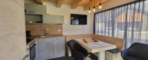 a kitchen with a table and chairs and a sink at Dijkstra`s Cottage 672 in Kötschach