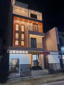 a tall building with a balcony on a street at Uthram Residency in Cochin