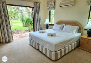 a bedroom with a bed with two flowers on it at Villa G5 - Selborne Golf Estate in Pennington +53 photos