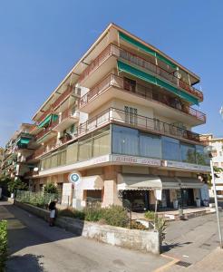 a tall building with balconies on the side of it at Soluzione Casa Pietra Ligure SEA VIEW in Pietra Ligure
