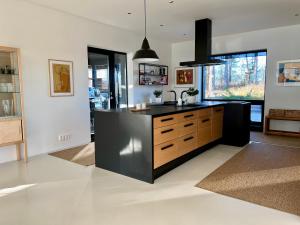a kitchen with a black counter and a sink at Unique lakehouse Villa Valo in Hollola