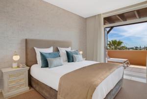 a bedroom with a large bed and a large window at Monte Santo Resort in Carvoeiro
