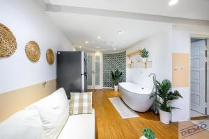 a bathroom with a large tub in a room at Luxe Paradise Residence 273 Ton Duc Thang in Hanoi +63 photos