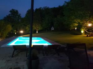 a swimming pool in a yard at night at Villa Mila in Ludbreg