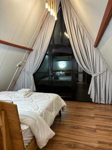 a bedroom with a bed and a tv in a room at Bidiya Desert Camp in Badīyah