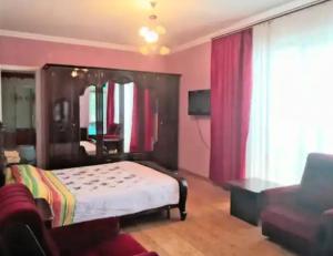a bedroom with a bed and a couch at Guest House Sirius in Chişinău +21 photos