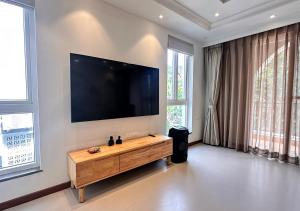 a living room with a large flat screen tv on the wall at VILLA M- SAVANNAH 7- 5BHK Brand New Villa in Calangute with Private Pool, Near Beach, free Breakfast, north goa in Goa