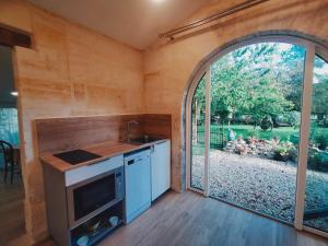 an interior view of a kitchen in a tiny house at Gîte Jardin Du Chay in Galgon