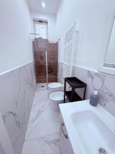 a white bathroom with a toilet and a sink at Villa Life in San Donato Milanese